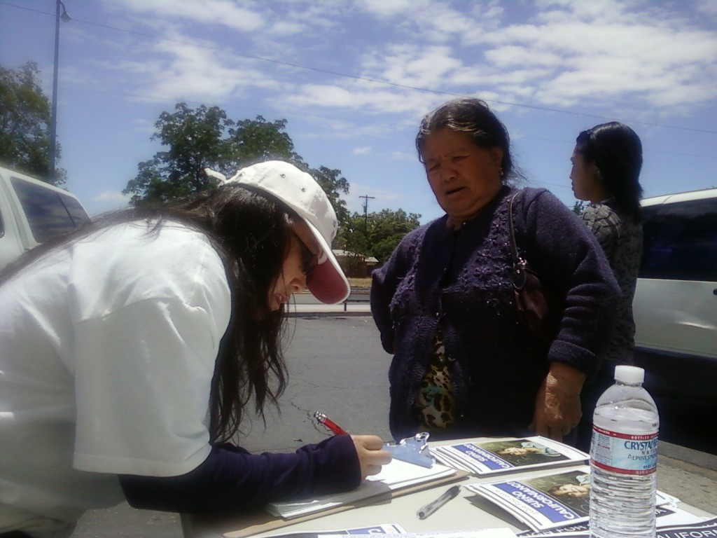 Molly Xiong assists a new citizen in becoming a registered voter.
